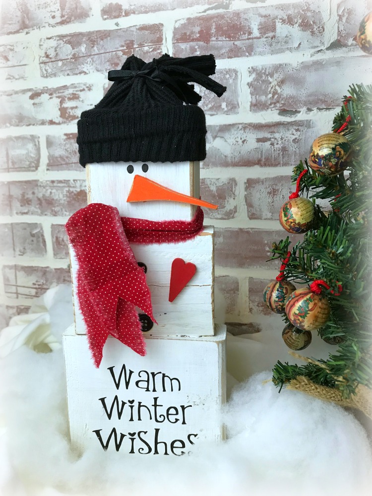 Wood Block Snowman Christmas Craft | blowingawayoutwest.com - The complete tutorial for this adorable Wood Block Snowman who offers Warm Winter Wishes #christmaswoodcraft #woodsnowman #warmwinterwishes #christmascraft #snowmancraft